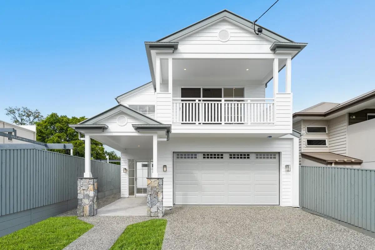 Two-storey Hamptons-style home with balcony, double garage and stone entry pillars in Carina Heights.