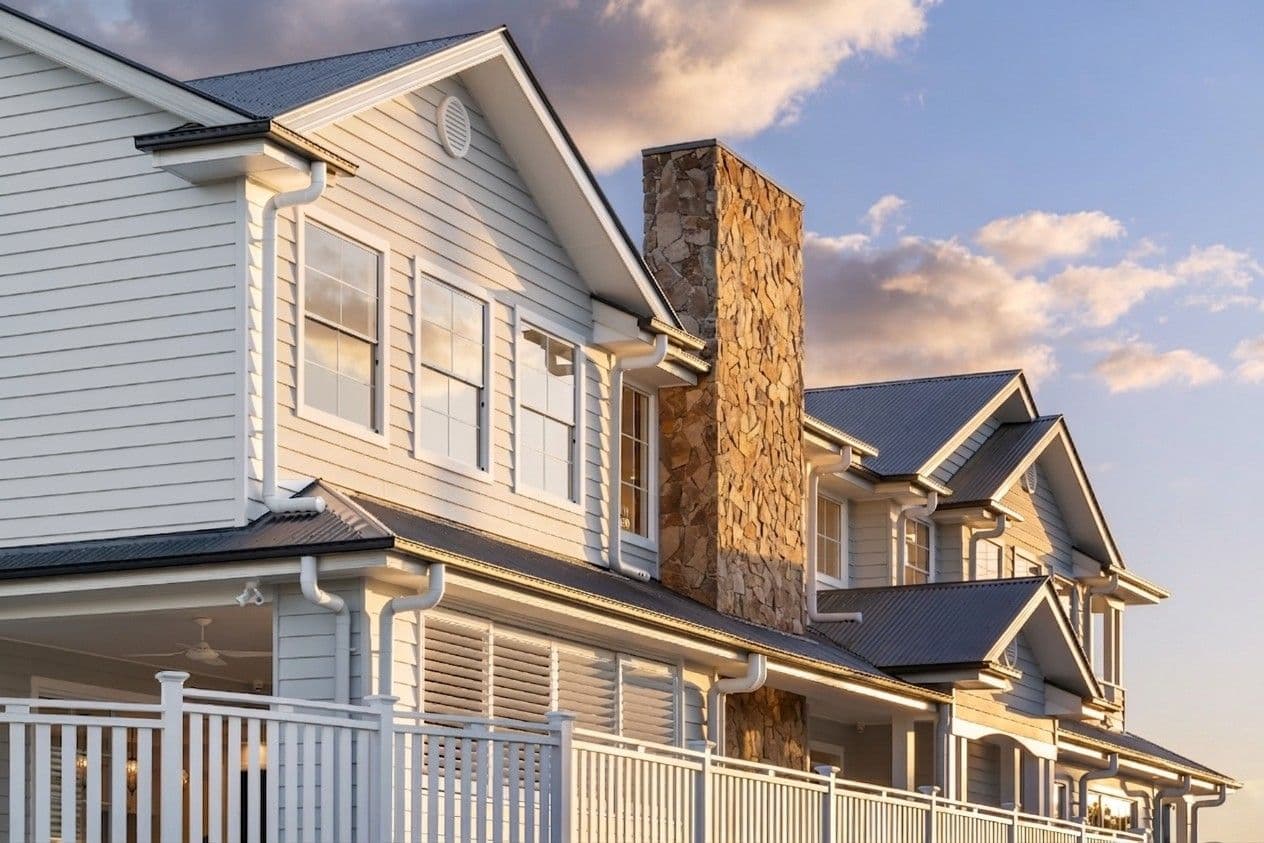 Two-storey Hamptons style custom home facade in Brisbane featuring weatherboard cladding and gable roof.