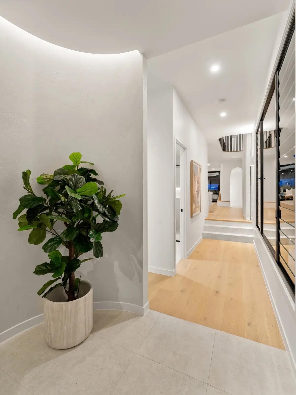A modern split level house plan in Brisbane featuring short internal stairs that naturally step down the block to the living zone.