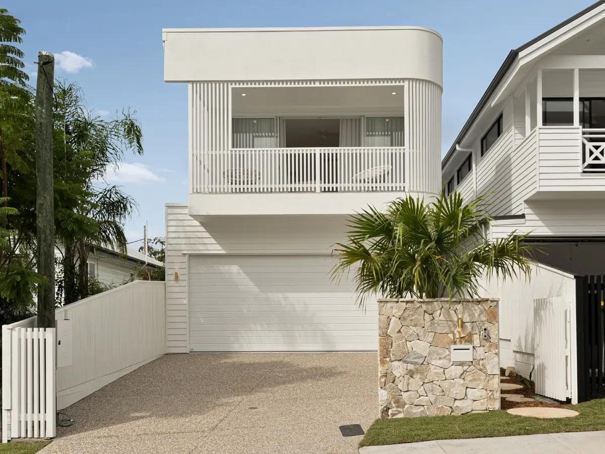 A modern black and white custom home built by a Brisbane small lot builder, showcasing the multi-dwelling Selbourne townhouses.