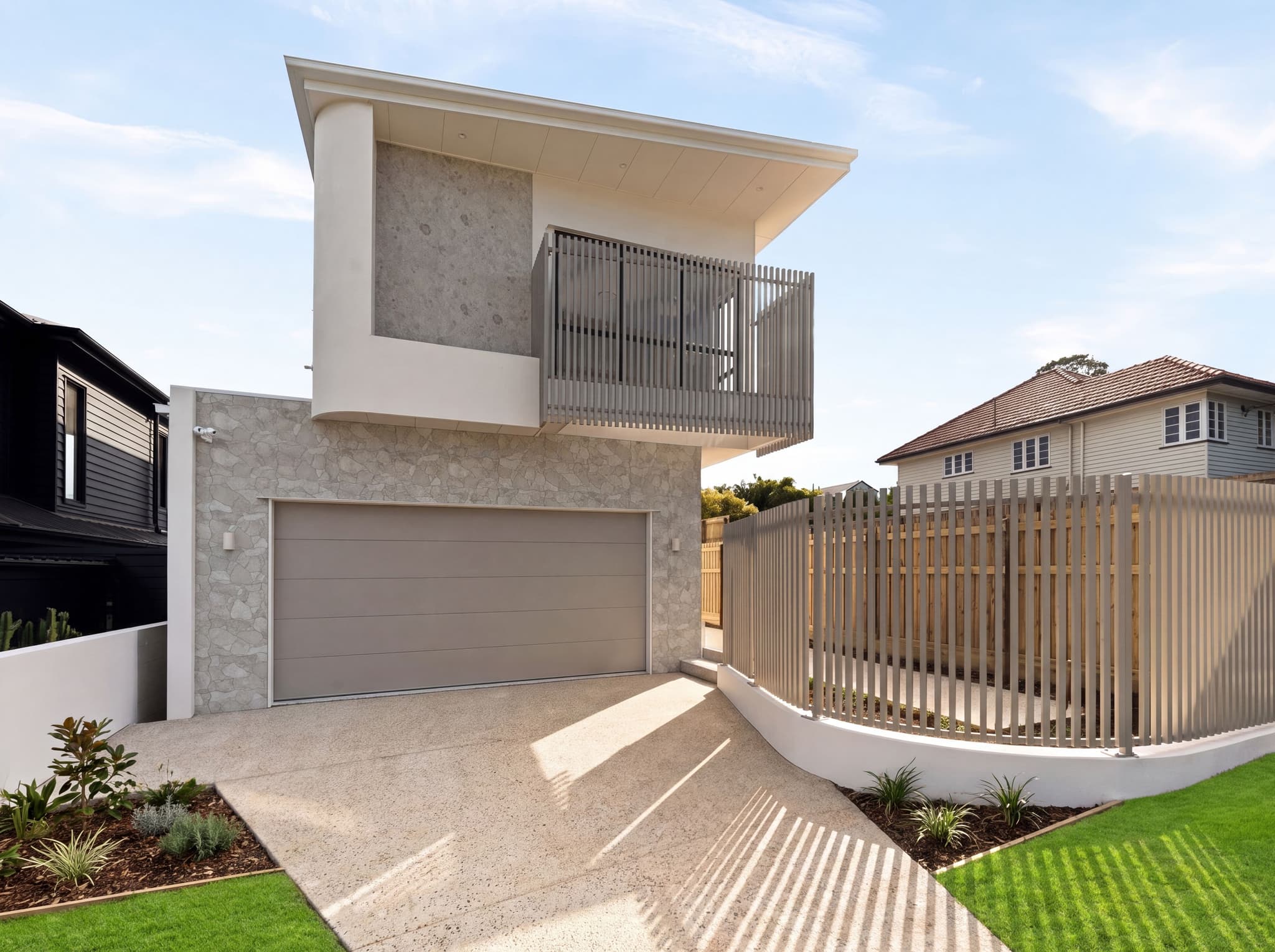 Custom home built by Flascon Construction Group in Brisbane, featuring a balcony and mixed stone and render facade