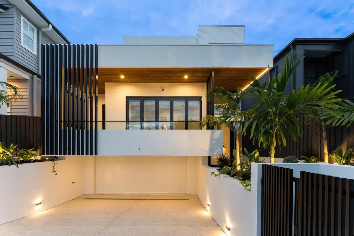 Contemporary two-storey Flascon home in Brisbane with living areas raised above an undercroft garage