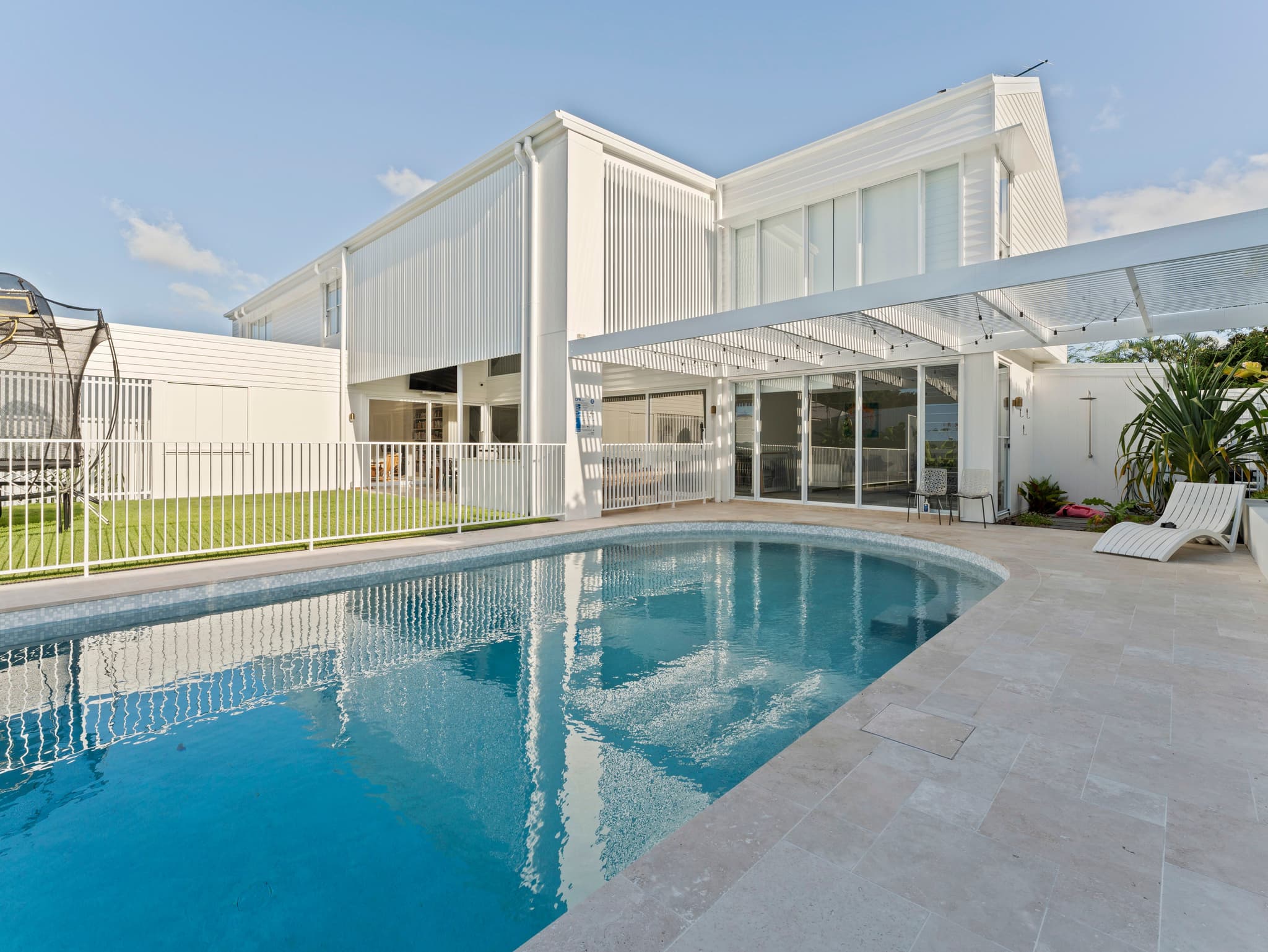 A custom Brisbane home with a seamlessly integrated swimming pool, showcasing concurrent construction and coordinated site management.