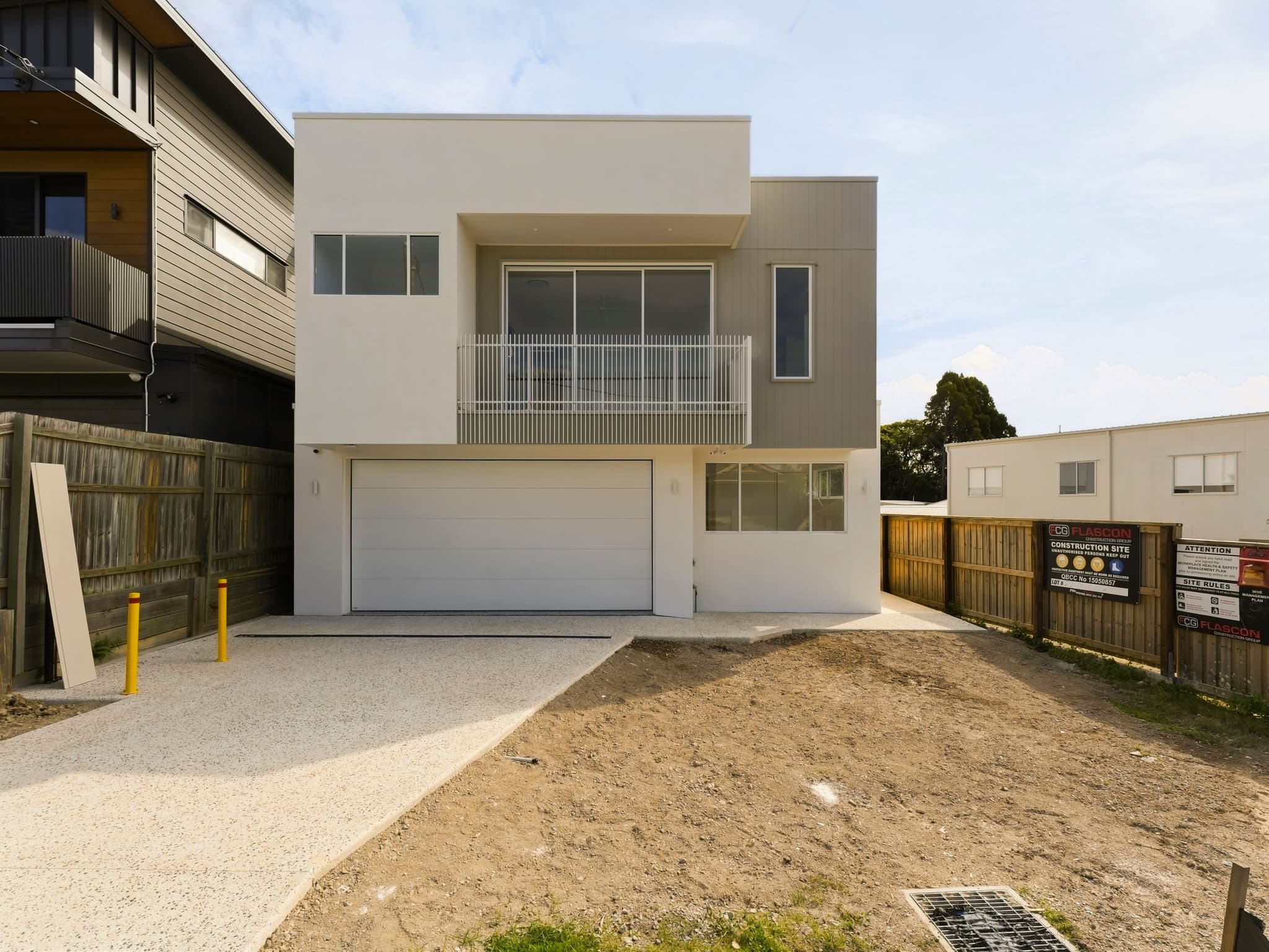 Orwell House, Coorparoo, a completed custom home by Flascon Construction Group before landscaping, with the driveway poured and stormwater drainage in place