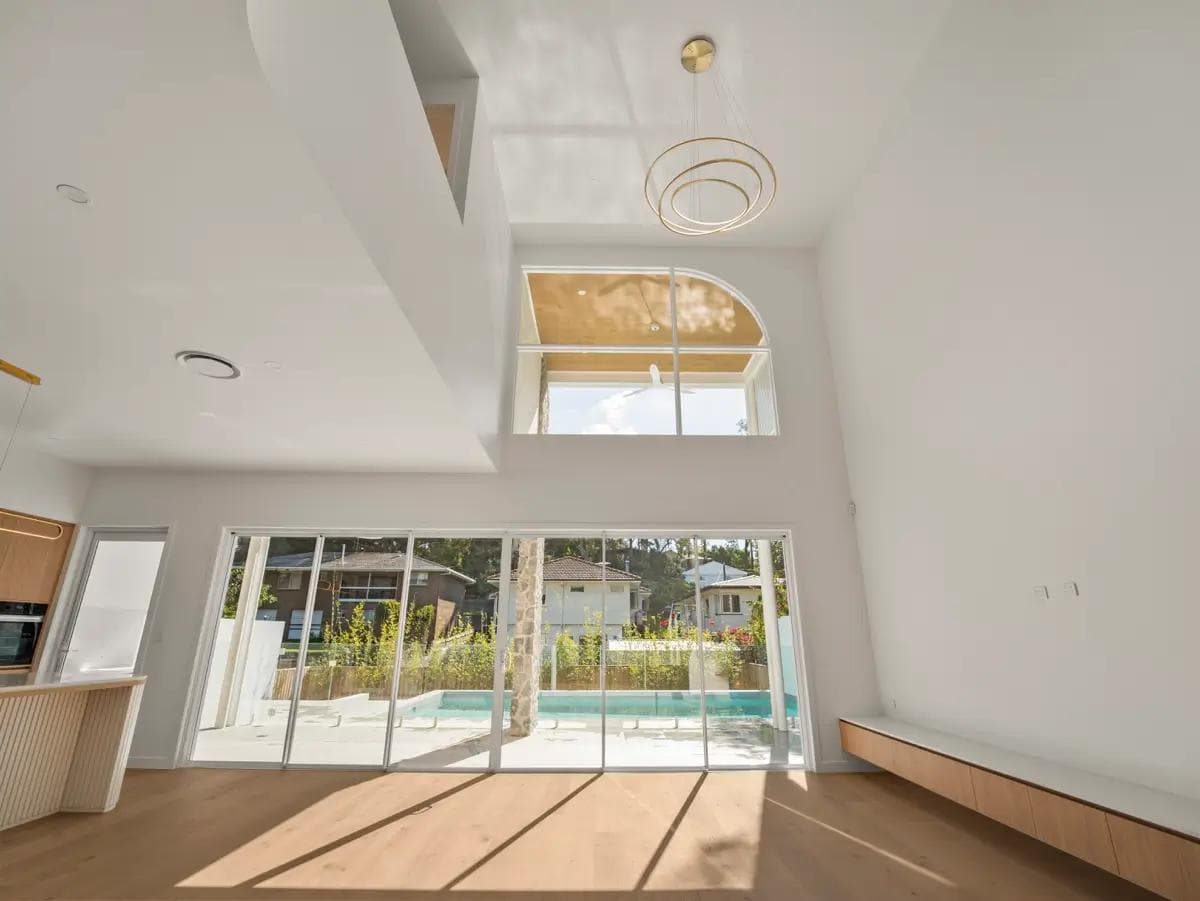 Sunlit open-plan living room in a Brisbane custom home.
