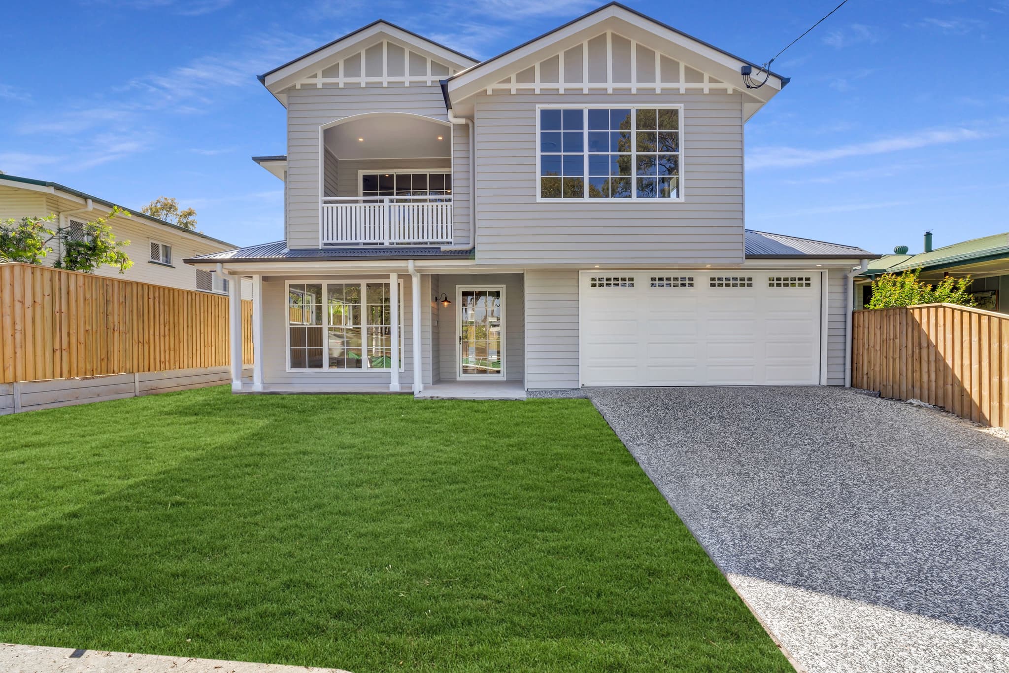 Two-storey Hamptons-style home with weatherboard cladding and double garage in Carina.